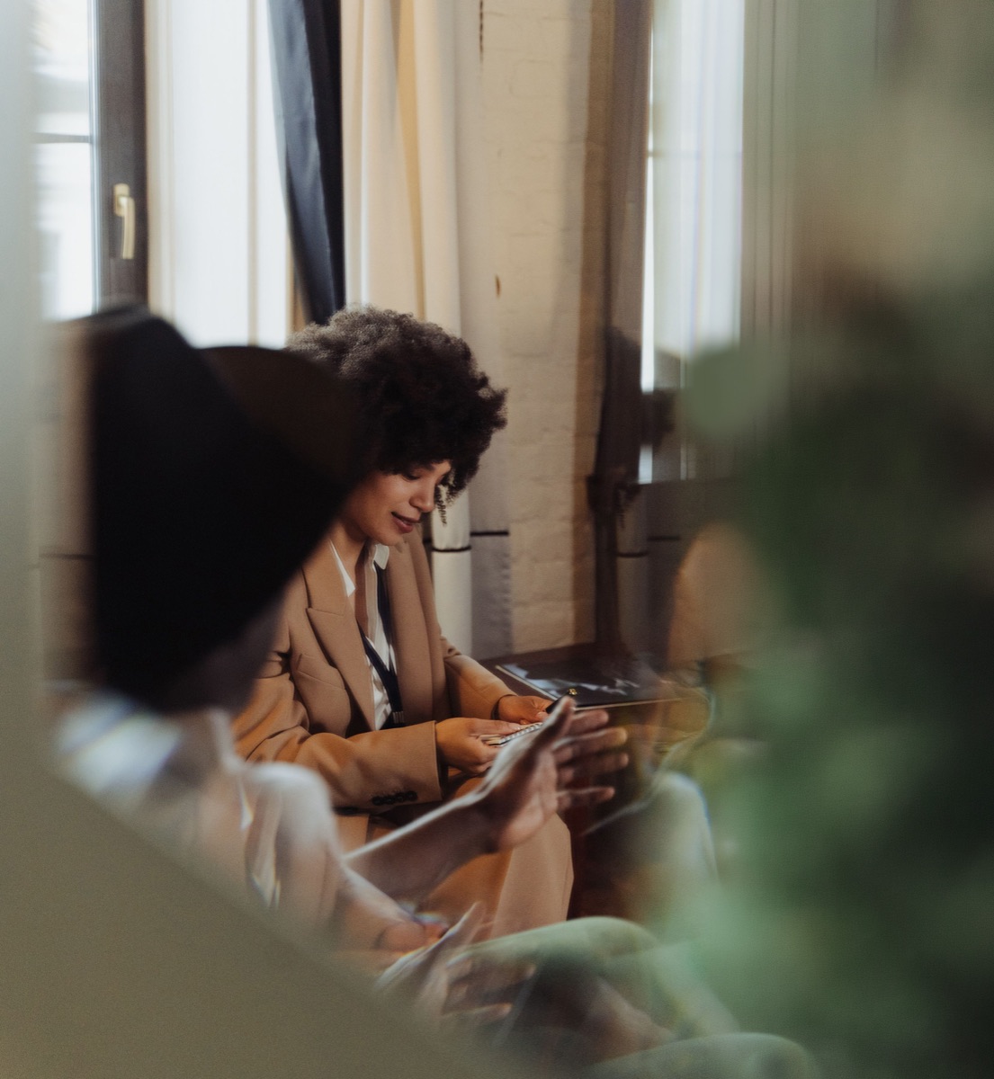 Two people looking at a tablet together in a sunlit room